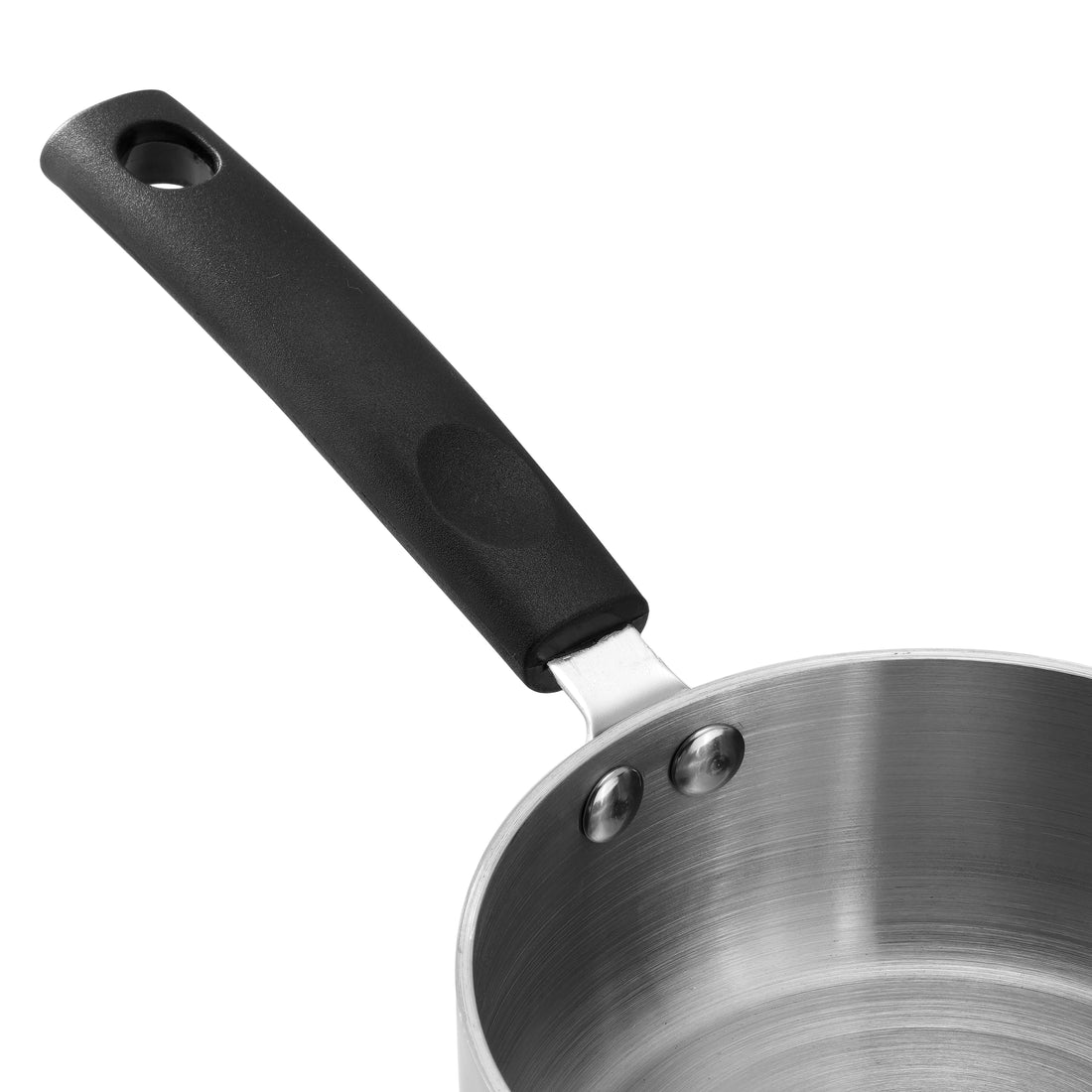 Stainless steel saucepan on a wooden kitchen counter with tomatoes and a basket of eggs.