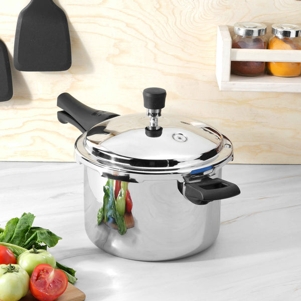 Triply outer lid pressure cooker with a mirror-polished body reflecting fresh vegetables, highlighting its premium stainless steel finish