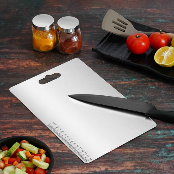 Stainless Steel Chopping Board with a knife, showing cut fruits on the left side and whole fruits on the right side